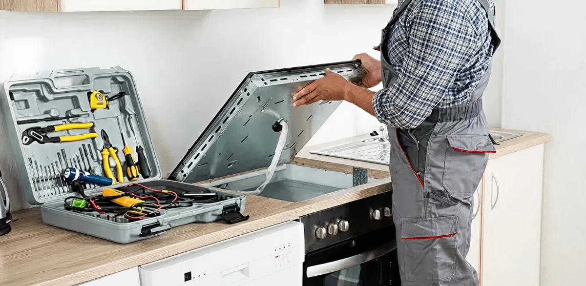 Handyman repairing a cooktop and checking wiring connections in El Paso, TX