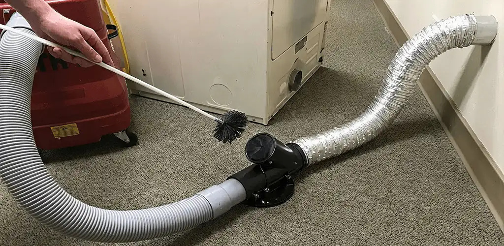 Dryer vent cleaning service removing lint from a dryer duct connection in El Paso, TX
