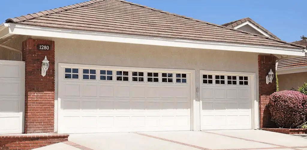 Residential garage door repair service for a double garage door in El Paso, TX