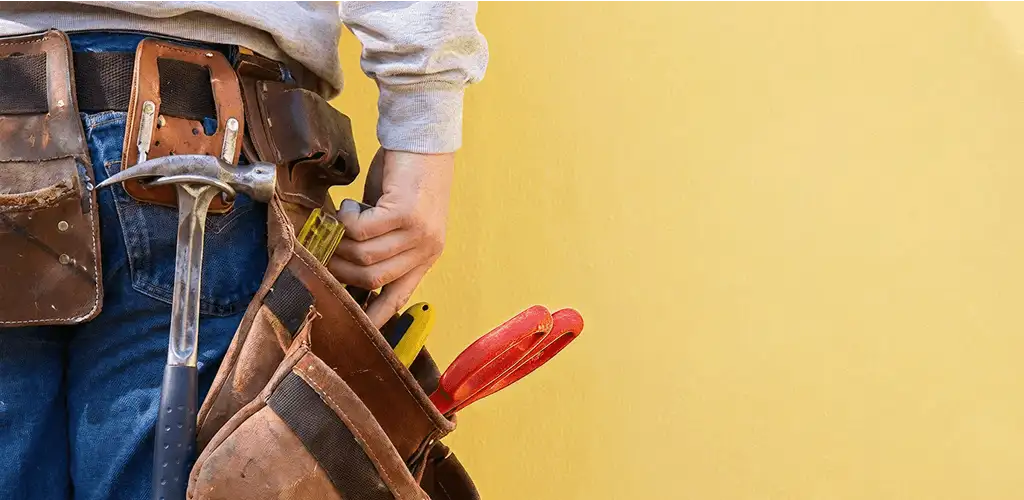 Handyman with tool belt ready for home repairs and maintenance in El Paso, TX