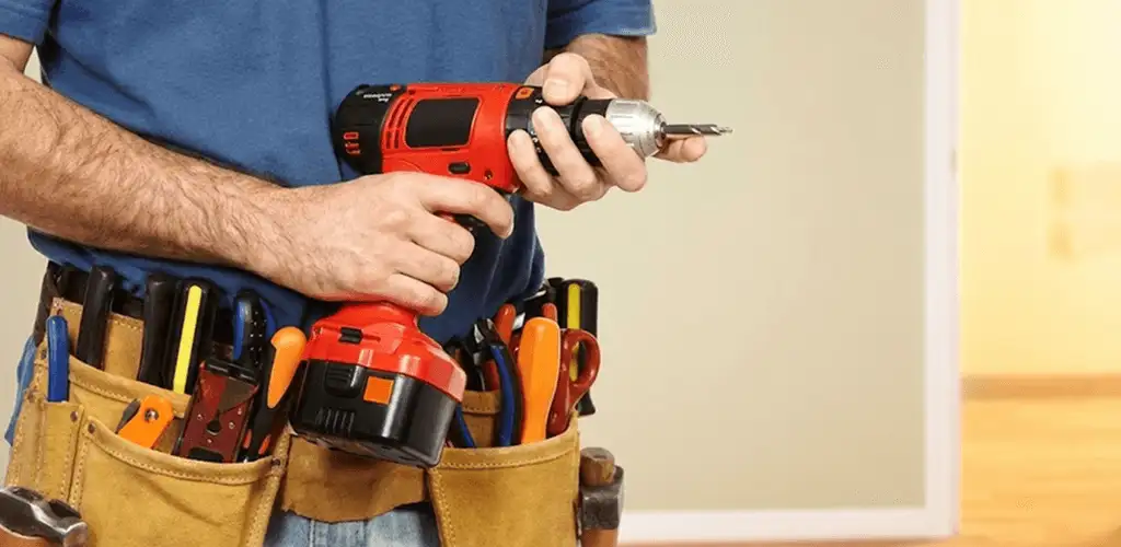 Handyman holding a power drill for home repairs and installations in El Paso, TX