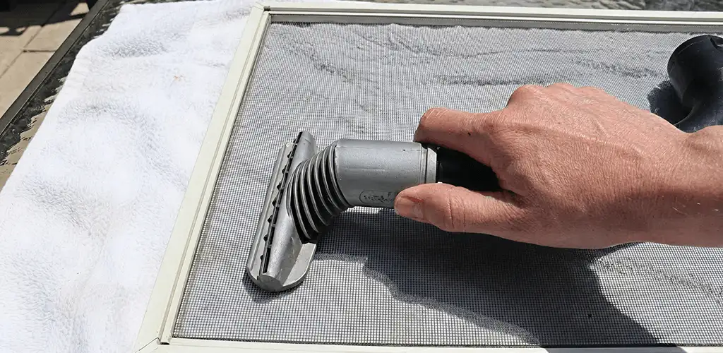 Window screen repair cleaning and fixing a damaged screen mesh in El Paso, TX
